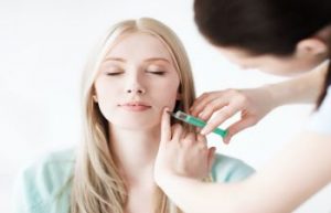 Woman during facial injectable treatment.