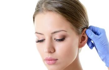 A beautiful woman at cosmetic ear consultation with a plastic surgeon.