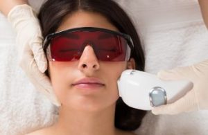 Woman undergoing facial laser therapy.