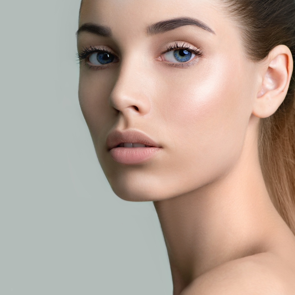 Beautiful young woman with clean perfect skin. Portrait of beauty model with natural nude make up and long eyelashes. Spa, skincare and wellness.
