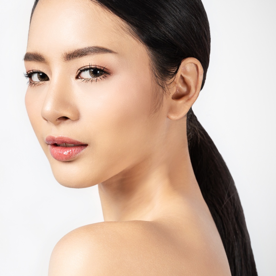 Closeup portrait of beauty asian woman with fair perfect healthy glow skin half face with copy space, young beautiful asia girl with pretty smile on face. Beauty korean clinic skincare concept banner