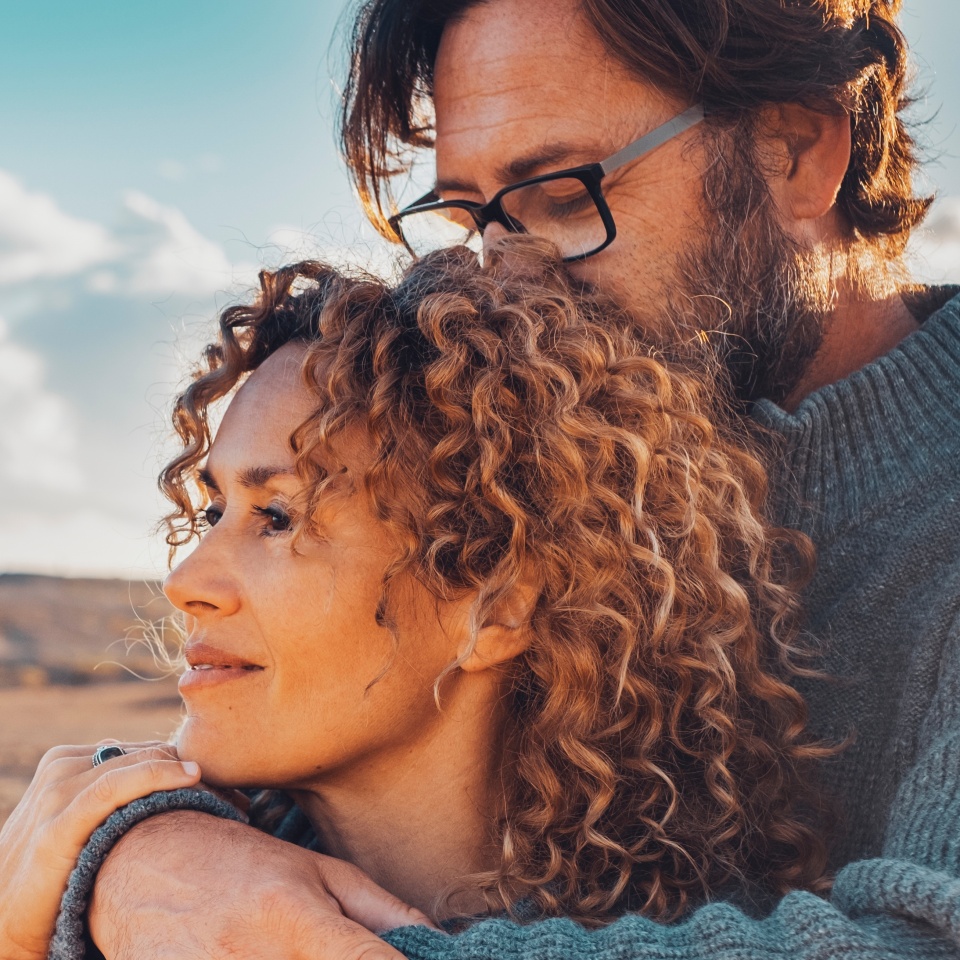 Young adult couple in love in outdoor leisure activity admiring travel destination. Contemplation. People traveler and adventure lifestyle. Man hug woman from behind. Looking away, togetherness two