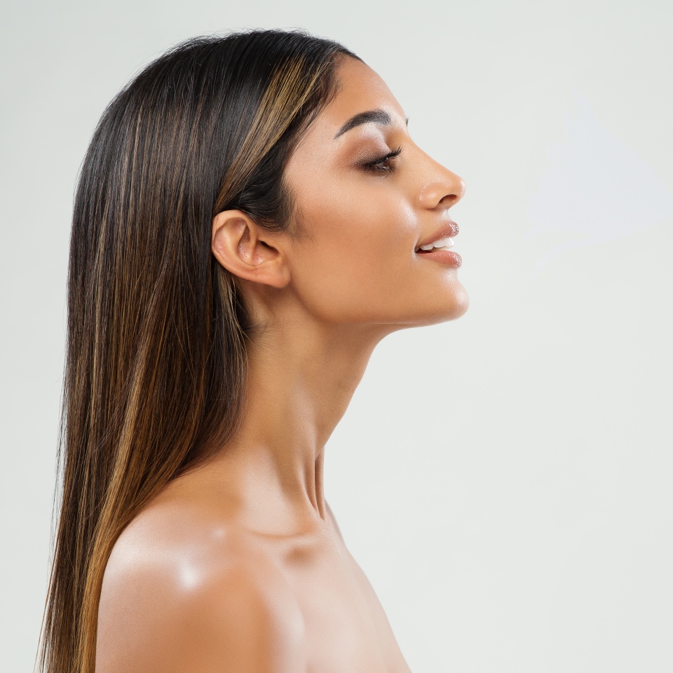 Beauty Girl Face Side View. Beautiful Indian Woman Profile over White. Women Chin and Neck Skin Facelift Massage. Nose Aesthetic Plastic Surgery