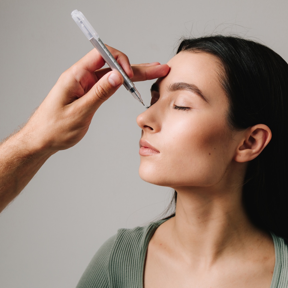 Plastic surgeon is marking rhinoplasty procedure plan on external nose and its surrounding structure. Accurate changing of nose size and proportion. Preparing for rhinoplasty nose surgery.