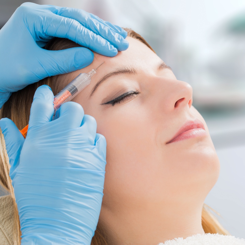 A woman undergoing facial dermal filler cosmetic treatment