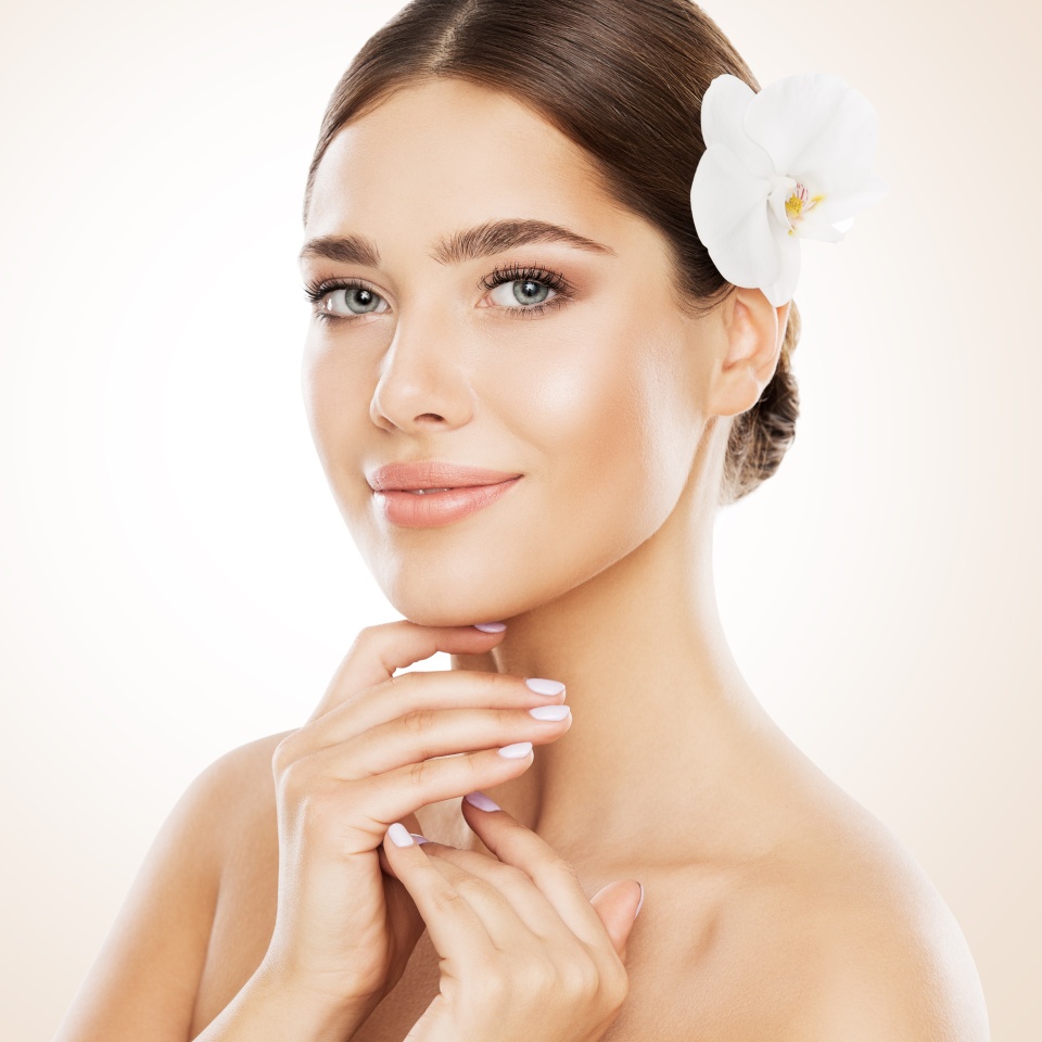 Woman Beauty, Face Skin Care and Natural Make Up, Girl with Orchid Flower in Straight Hair, Beautiful Makeup and Skincare