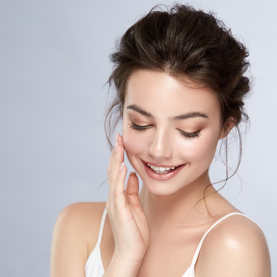 cute girl with natural make-up smiling and looking down, young and healthy woman facial care, cosmetology and dental concept