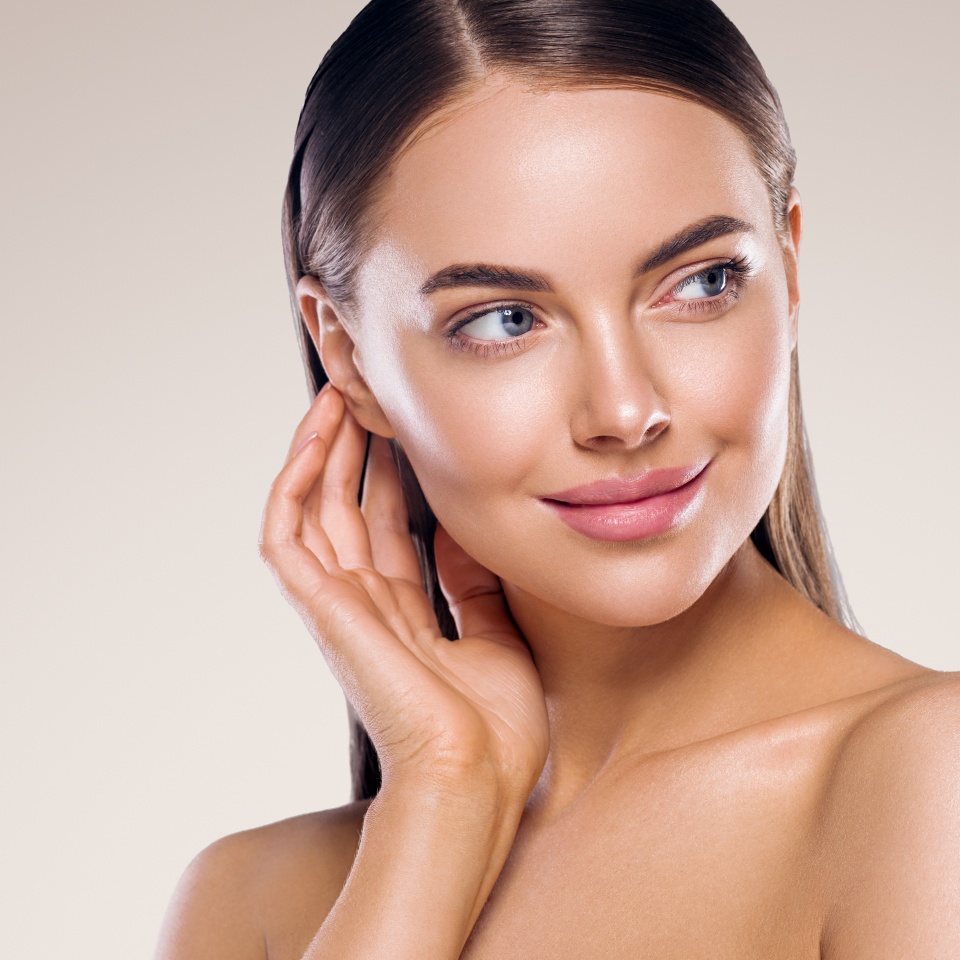 Woman beauty face healthy clean fresh skin natural make up beauty eyes and lipsfemale young model with hand touching face manicure nails