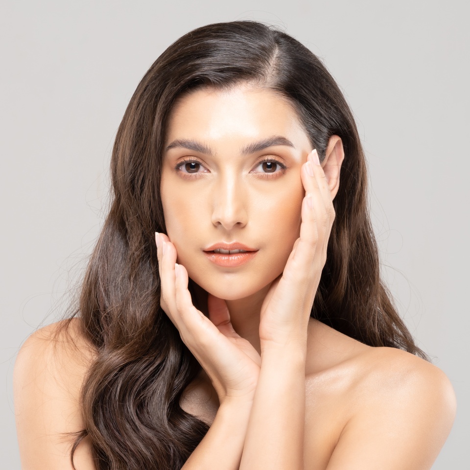 Beautiful Glamour indian woman touch cheek smile with clean and fresh skin Happiness and cheerful with positive emotional,isolate on grey background,Beauty Cosmetics and spa Facial treatment Concept