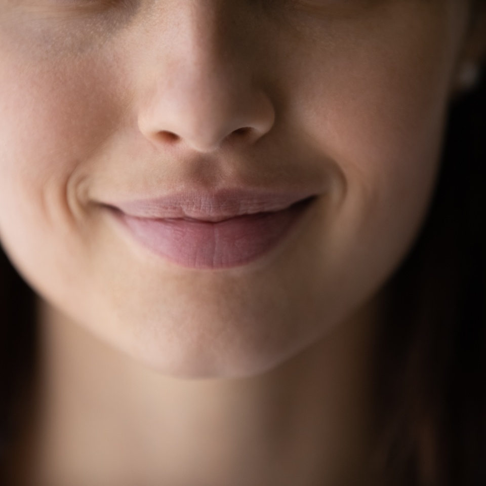 Crop close up of beautiful young woman mouth lips without makeup, lower face details, attractive female with healthy perfect clean smooth skin, lip balm, skincare and natural beauty concept