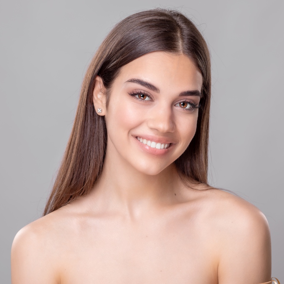Beautiful young woman with perfect skin. Portrait of beauty model with natural nude make up. Spa, skincare and wellness. Close up, copyspace.