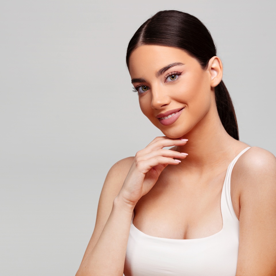 Beautiful woman on bright gray background. Beauty portrait.