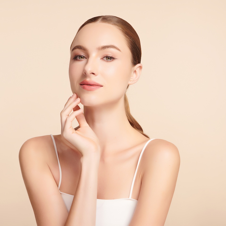 Beautiful young woman with clean fresh skin on beige background, Face care, Facial treatment, Cosmetology, beauty and spa, women portrait.