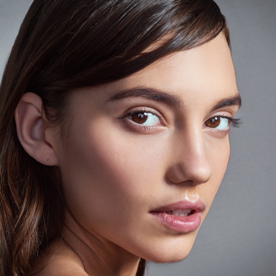 Portrait, natural and beauty of woman with glow, shine and health isolated on gray studio background. Face, skincare and confident model with cosmetics at spa for dermatology, makeup and wellness