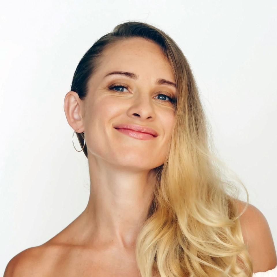 Beautiful woman touching skin on nose and looking into camera during shooting video blog. Woman beauty blogger posing and looking into camera