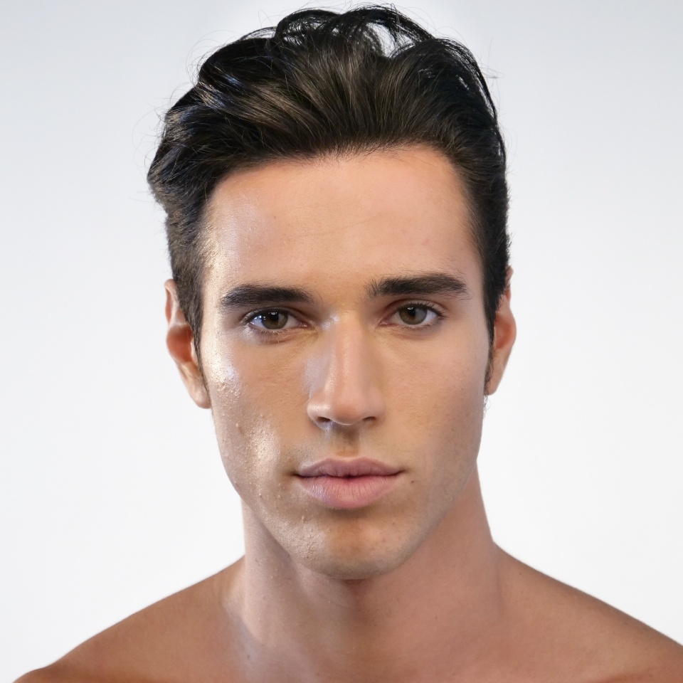 Portrait of a beautiful smiling man showing white teeth looking into camera or making faces of doubt or blunders with perfect skin and combed hair.