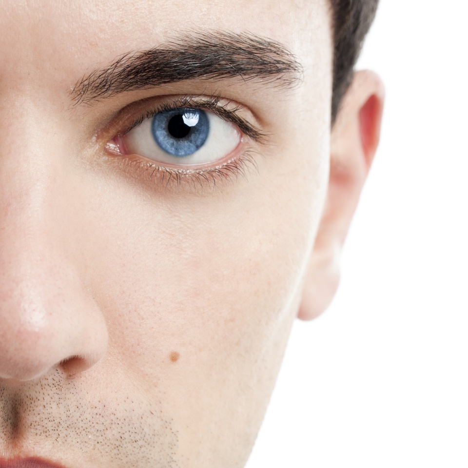 Close-up portrait of handsome young man with blue eyes