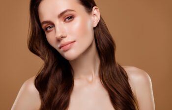 Portrait of pretty charming lady enjoying new cream lotion for pure perfect skin on pastel color background