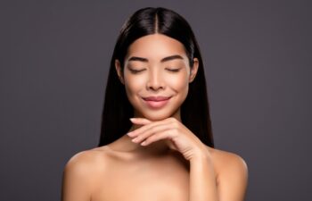 Photo of dreamy inspired model stunning korean brunette lady hand chin isolated grey color background