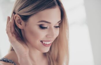 Close up portrait of successful, pretty, charming, gorgeous, cheerful, cute, modern, naked, nude, natural, positive, correcting her hair behind ear, skincare, bodycare, healthcare concept