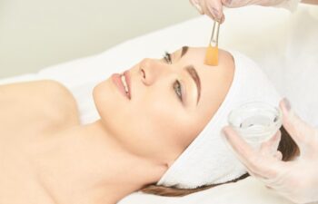 Facial brush peel retinol treatment. Beauty woman peeling procedure. Cosmetology young girl therapy.Hyaluronic acid.