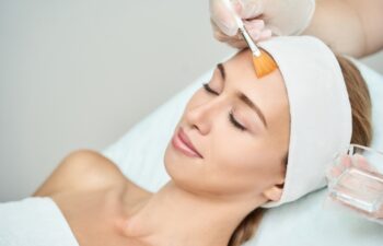 Cosmetology beauty procedure. Young woman skin care. Beautiful female person. Rejuvenation treatment. Facial chemical peel therapy. Clinical healthcare. Doctor hand. Dermatology cleanser.