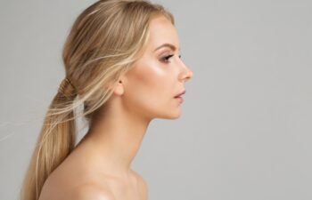 Woman Face Profile. Young Girl Portrait with Smooth healthy Skin. Model Facial Side View over Gray. Body and Neck Skin Care Cosmetology