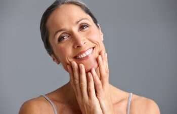 She takes good care of her skin. Studio portrait of a beautiful mature woman posing against a gray background.