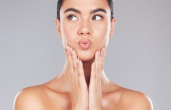 Skincare, lips care and beauty woman with facial cosmetics, luxury natural makeup or spa self care routine. Dermatology, healthcare and aesthetic model with clean glowing skin, wellness and puckering