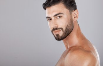 Man, studio portrait and skincare with beauty, cosmetics and wellness by studio backdrop with natural glow. Model, self care and healthy aesthetic for cosmetic self love, body care and radiant facial