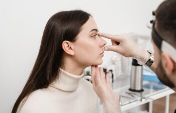 Septoplasty is surgery to correct deviated septum. Rhinoplasty is reshaping nose surgery for change appearance of the nose and improve breathing. Surgeon is touching and examining girl nose