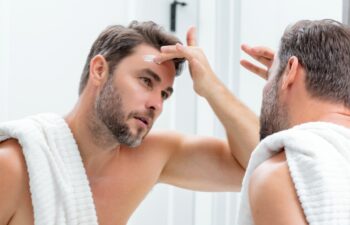 Cosmetic cream for man. Spa male model, skincare product for skin face. Morning mask for skin with anti-aging effect. Skin care. Male face cream. Man with perfect soft skin. Beauty cosmetic product.