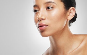 We all want that natural, healthy glow. Studio shot of an attractive young woman posing against a grey background.