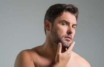 Cosmetic cream for man. Spa male model, skincare product for skin face. Morning mask for skin with anti-aging effect. Skin care. Male face cream. Man with perfect soft skin. Beauty cosmetic product.