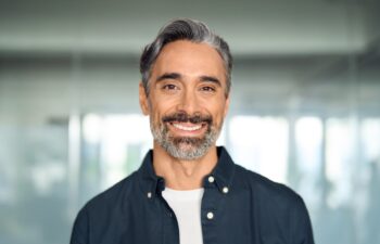 Happy middle aged 50 years old professional business man, smiling older executive manager, mature bearded businessman entrepreneur standing in office at work looking at camera, headshot portrait.