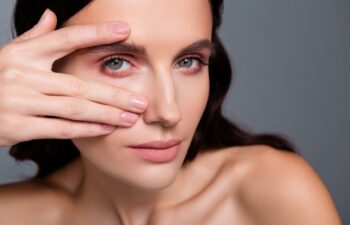 Close up photo of woman touch fingers eyes look isolated grey color background
