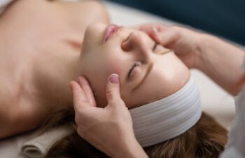 Woman with facial mask. Cosmetic procedure. Beauty spa and cosmetology. Beauty treatments. Facial lifting in SPA salon. Cosmetologist girl does facial massage. Cosmetic procedure. Beauty cosmetology.