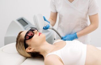 Laser hair removal procedure in an aesthetic clinic, focusing on facial hair removal from a female patient. Highlights advanced technology in hair removal and personalized skincare.