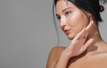 Stunning side view portrait of a young woman with radiant, healthy skin in soft natural lighting. Ideal for beauty, skincare, and cosmetic promotions, focusing on elegance and glow.