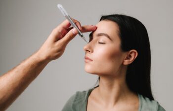 Plastic surgeon is marking rhinoplasty procedure plan on external nose and its surrounding structure. Accurate changing of nose size and proportion. Preparing for rhinoplasty nose surgery.