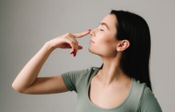 Septoplasty. Young girl is suffering from deviated nasal septum. Healing breathing issues with rhinoplasty. Abuse of vasoconstrictor nasal drops is leading to addiction