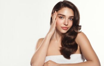 Studio, shine and portrait of woman, touch and treatment of skincare, soft and glow of body in results. White background, face of radiant female model, concept for skin, dermatology and cosmetics.