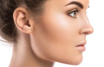 Female face in profile on white background