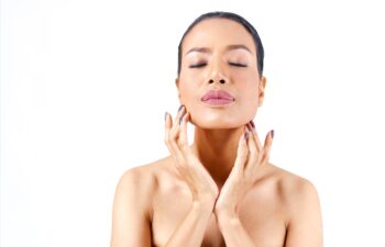 Close up beautiful middle age Asian woman's face hands touching her chin isolated on white background , beauty concept
