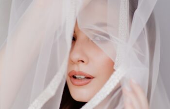 portrait of a beautiful young woman in a white robe under a wedding veil. the bride's morning before the ceremony and meeting with the groom. Newlyweds.